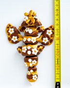 Bee dragon figure next to measuring tape for scale