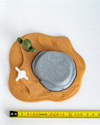 Desert scene base next to measuring tape for scale