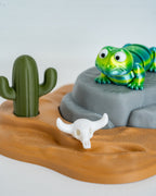 Green lizard figurine with desert display stand