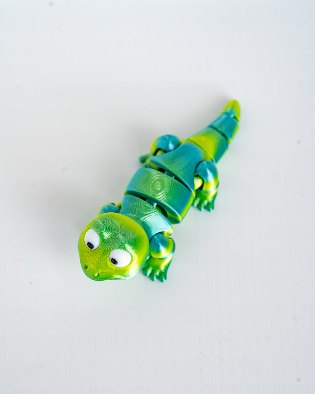 Green lizard figure viewed from angle
