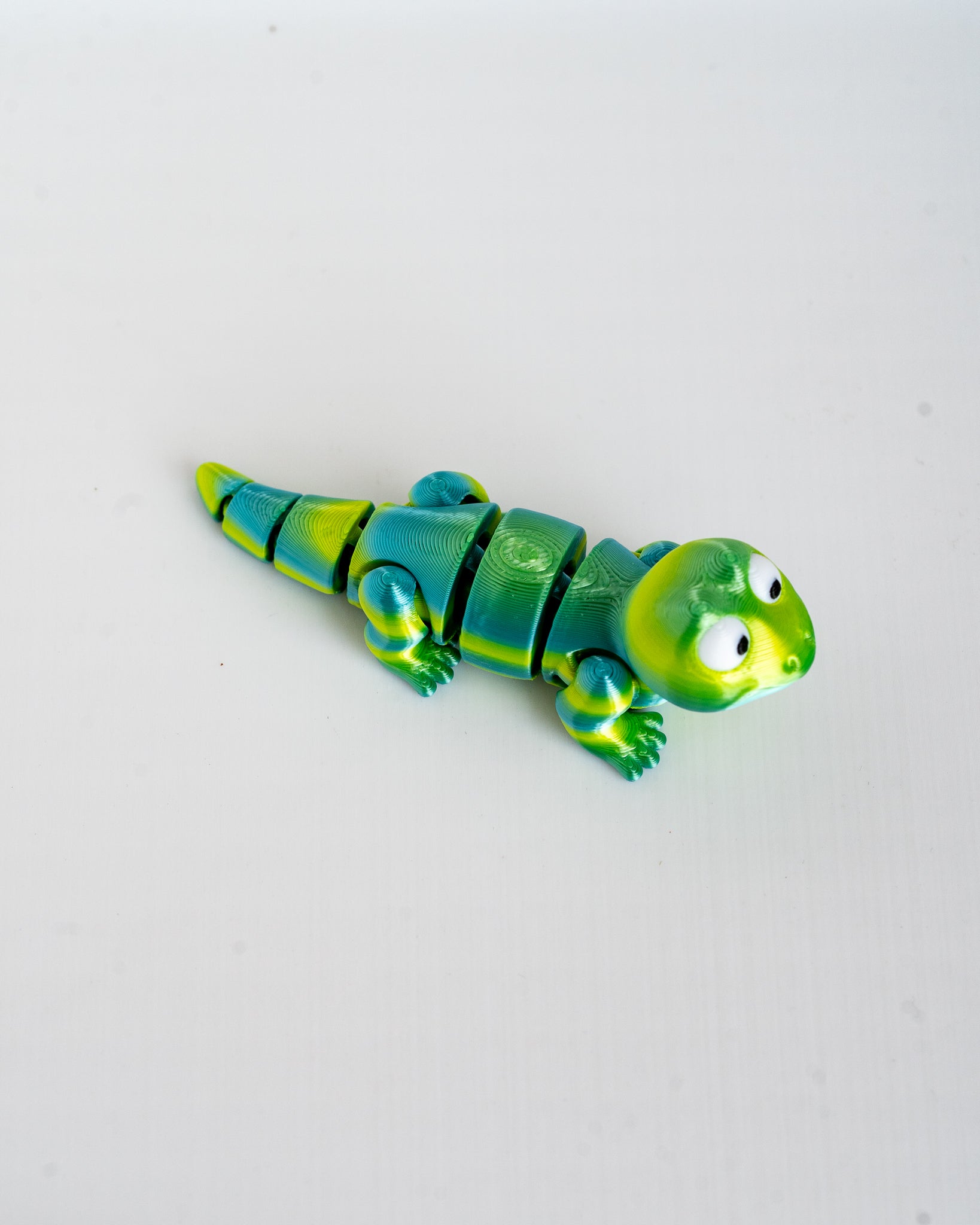 Articulated green lizard figure viewed from side
