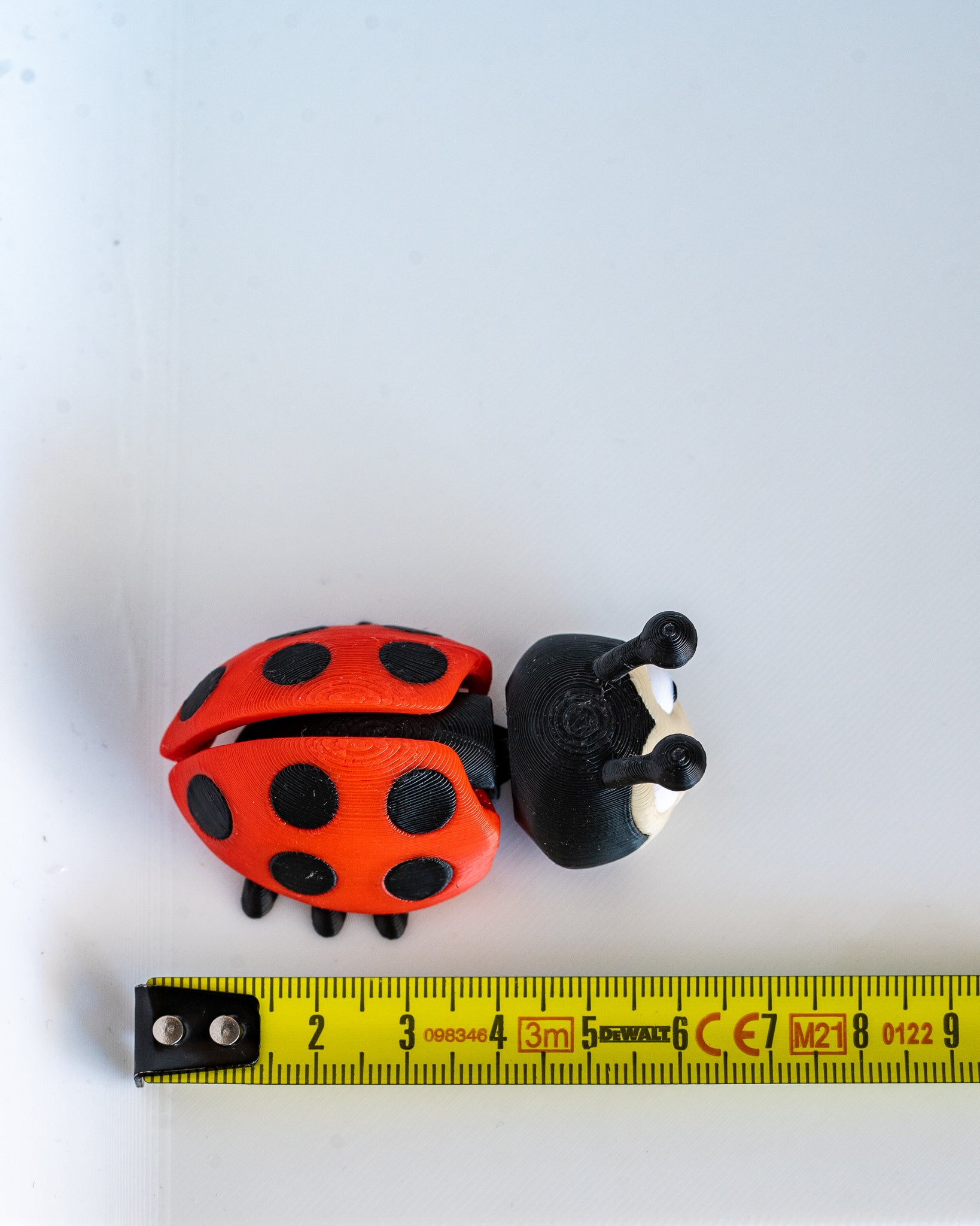 Ladybug figure next to measuring tape for scale