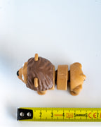 Lion figure next to measuring tape for scale