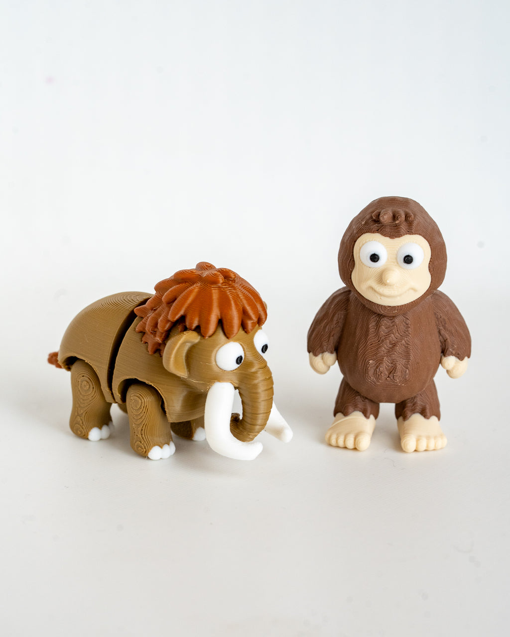 Mammoth and sasquatch figures viewed from front