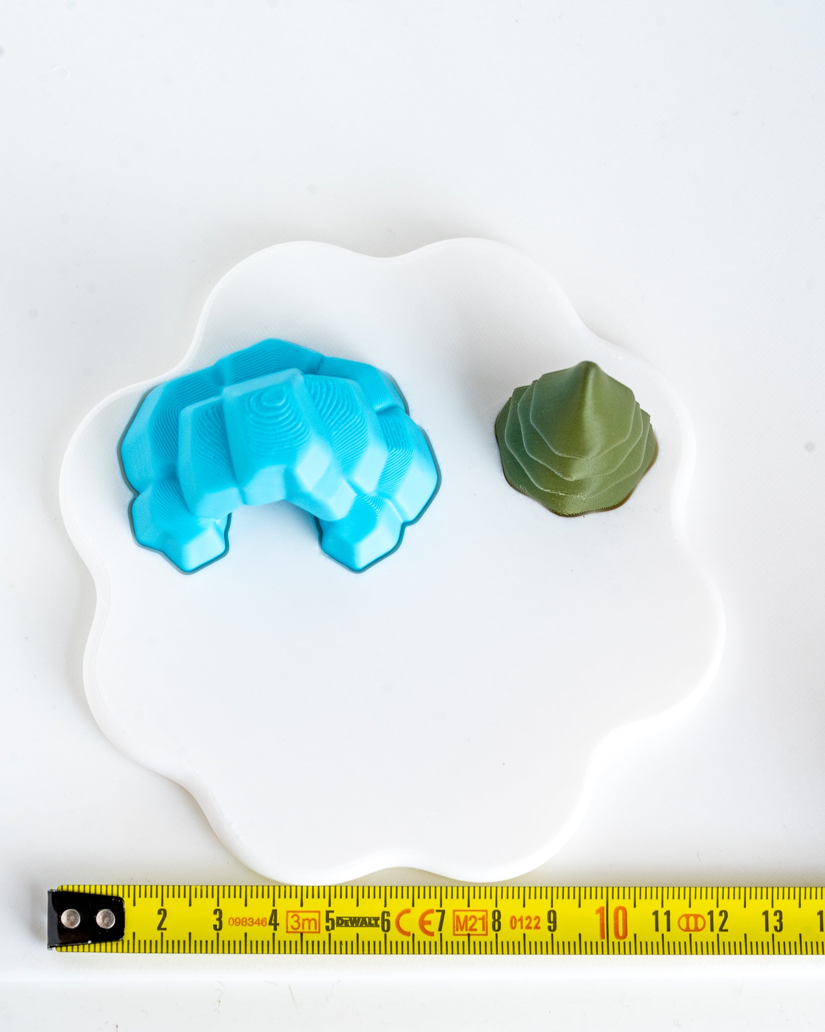 Ice cave and tree display base next to measuring tape for scale