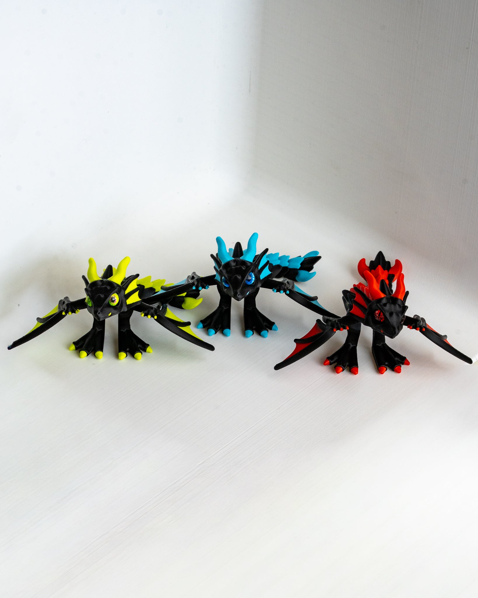 Trio of articulated neon dragons in Neon Green Sky Blue and Fire Red