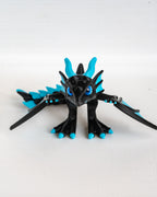 Black and blue dragon figurine on a white background