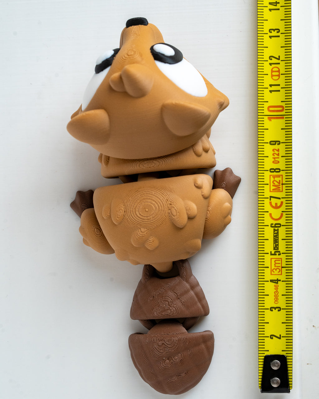 Beaver figure next to measuring tape for scale