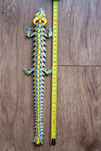 Dragon figure next to measuring tape for scale