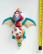 Pterodactyl figure next to measuring tape for scale