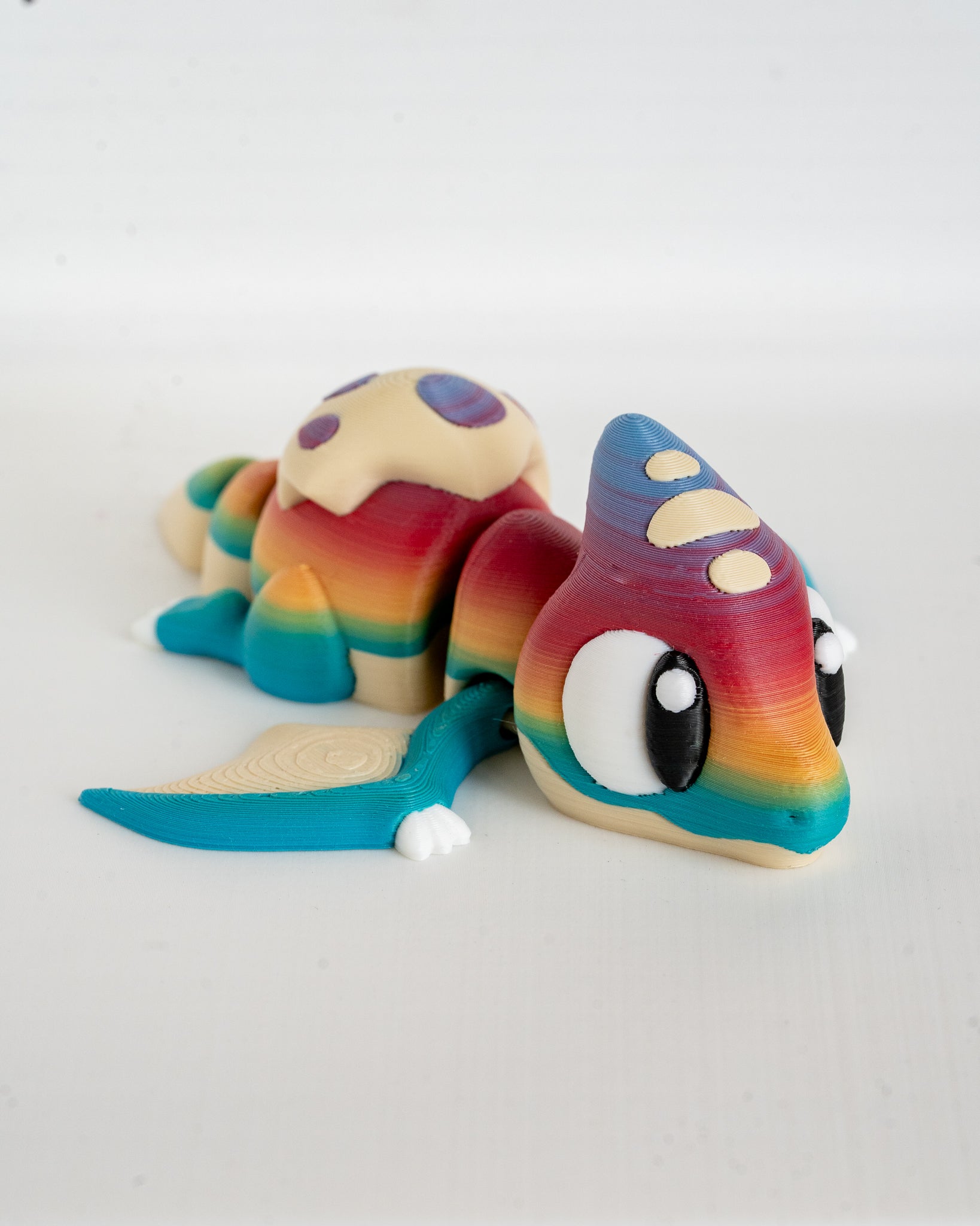Articulated pterodactyl figurine with rainbow colours