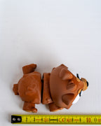 Bear figure next to measuring tape for scale