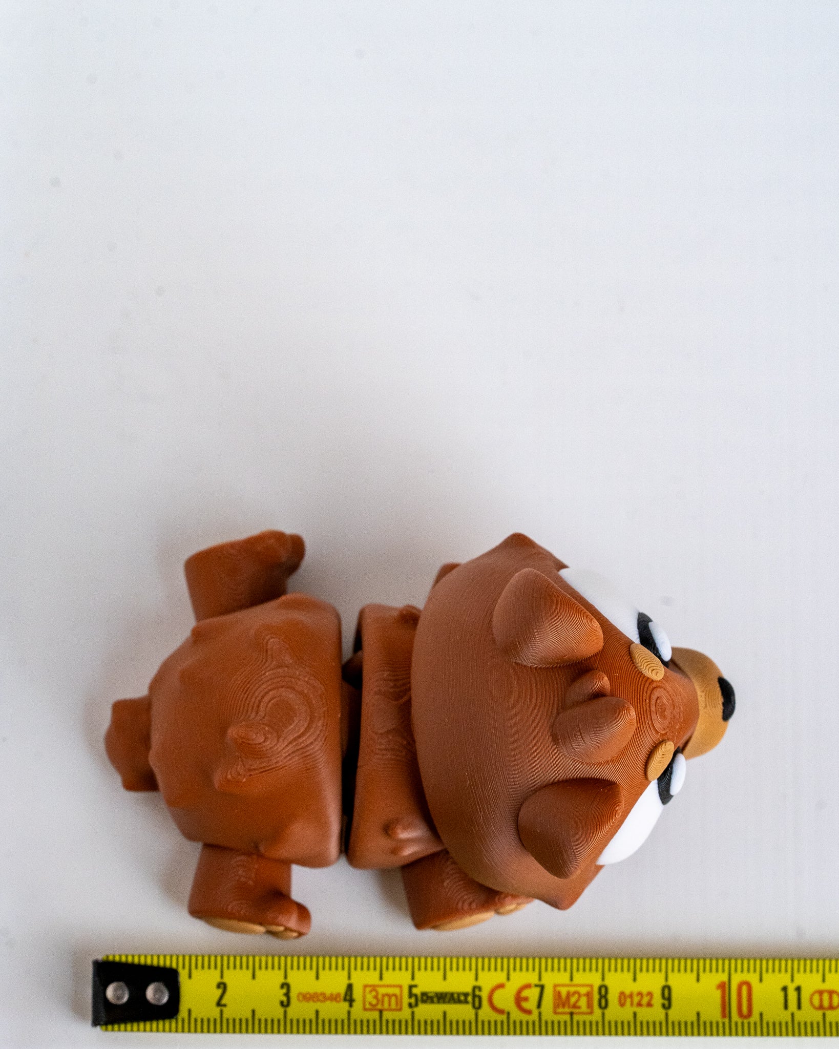 Bear figure next to measuring tape for scale
