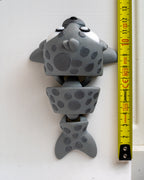 Seal figure next to measuring tape for scale