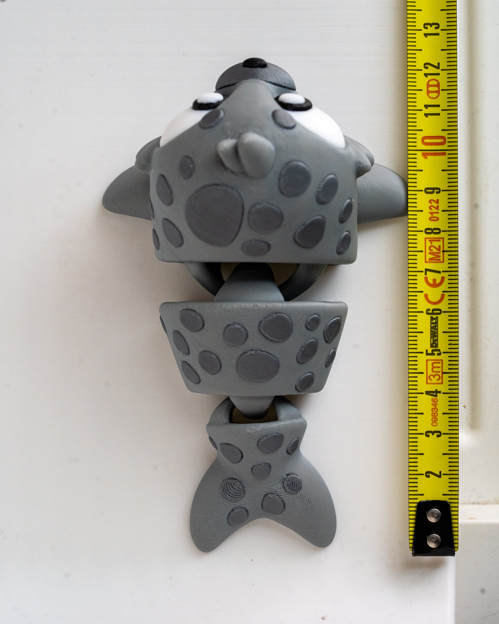 Seal figure next to measuring tape for scale