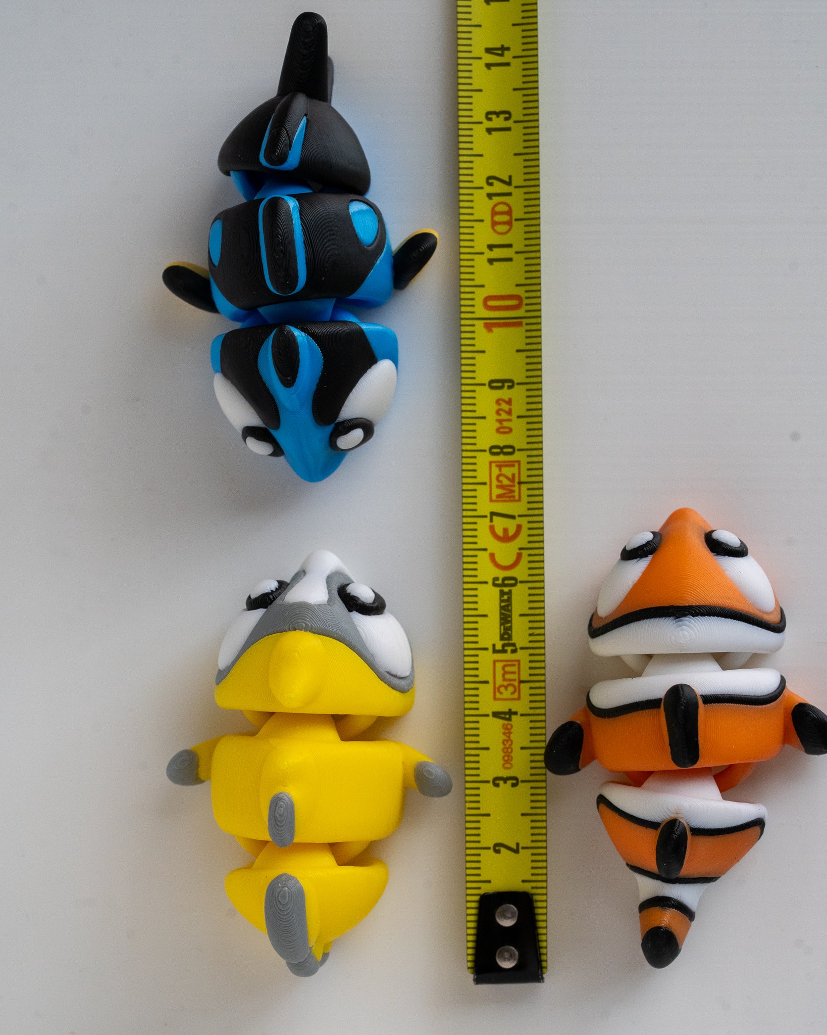Fish figure set next to measuring tape for scale