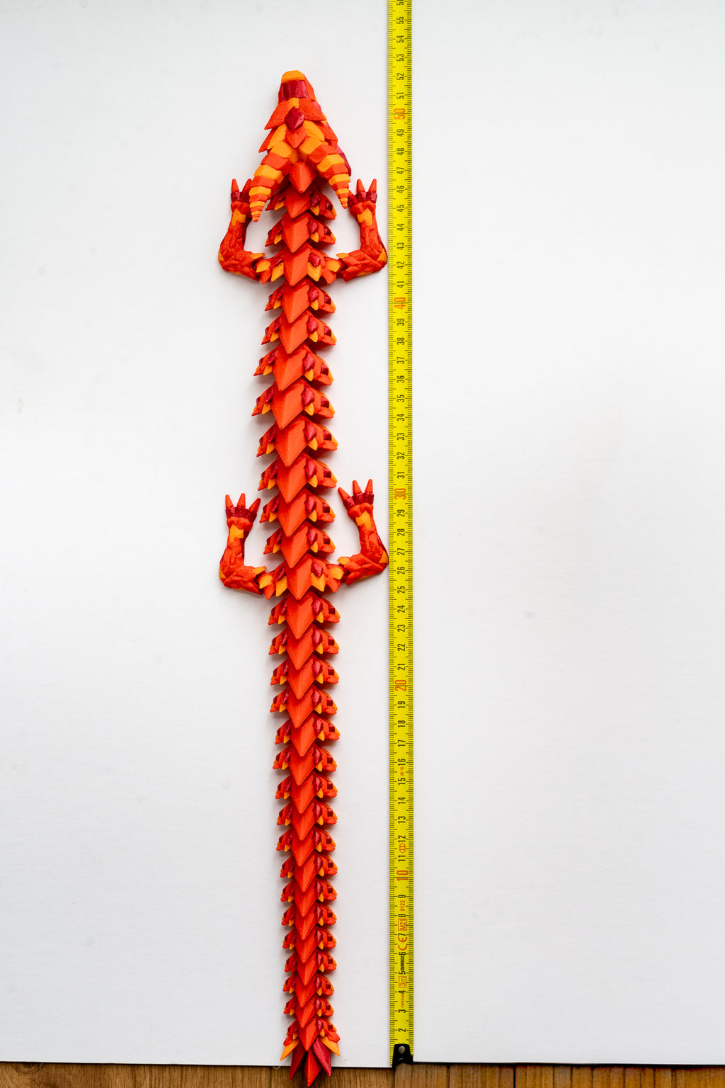 fire Dragon figure next to measuring tape for scale