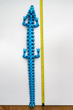 Dragon figure next to measuring tape for scale