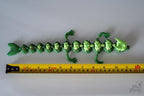Green dragon next to measuring tape for scale