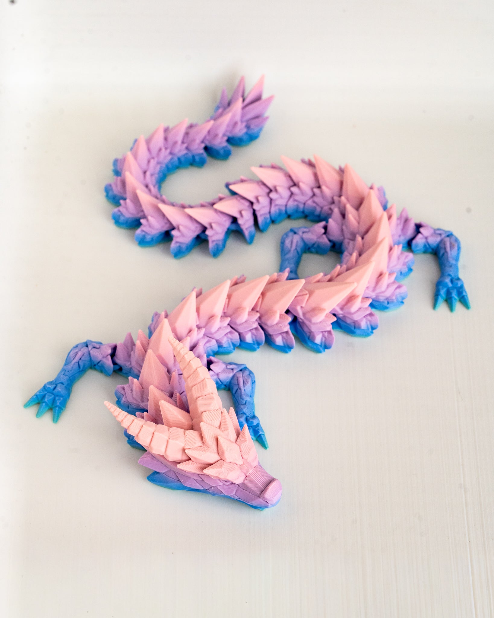 Pink and blue dragon on a light background