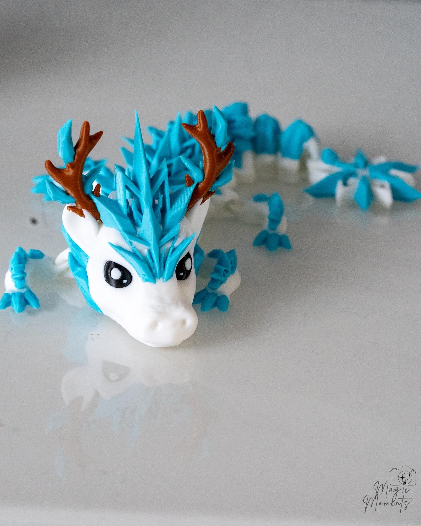 Blue ice dragon figure with snowflake tail and fantasy design