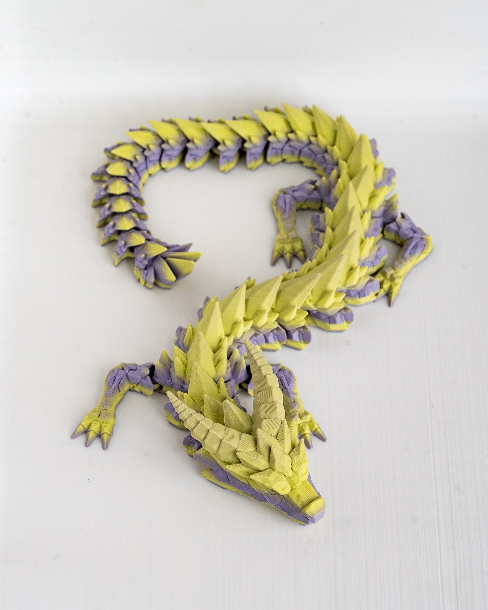 Yellow and purple dragon on a white background