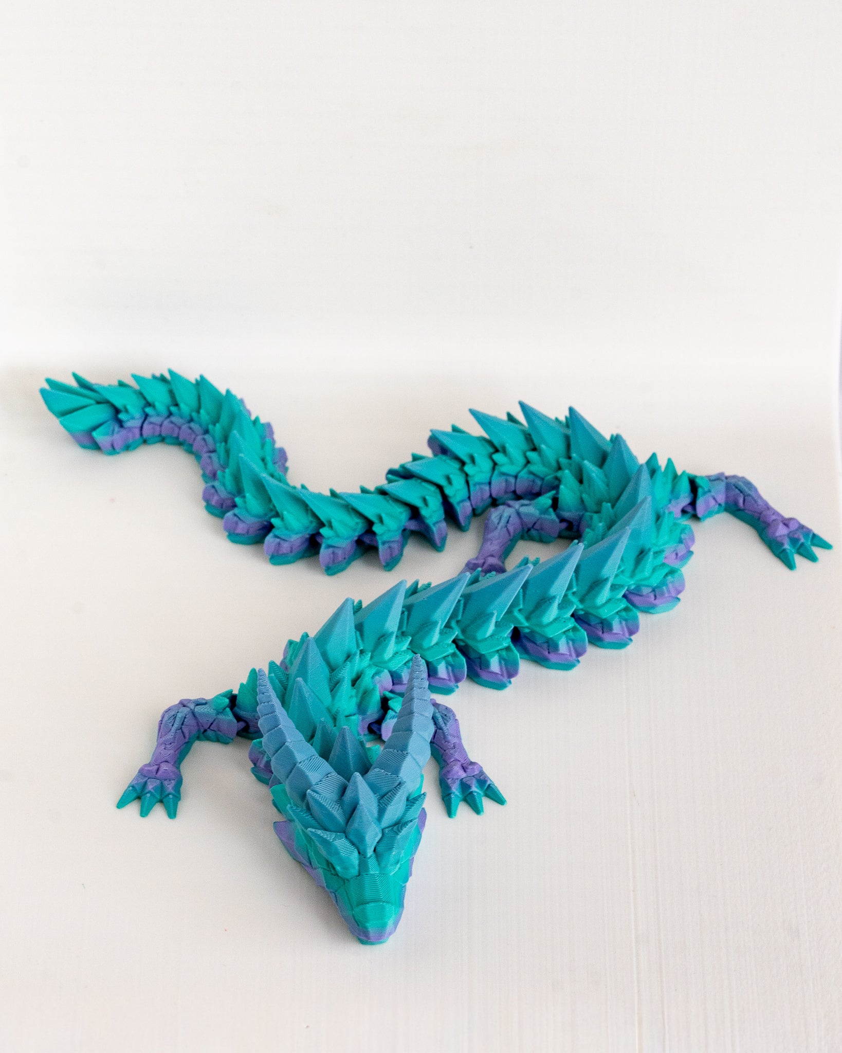 Blue and purple dragon on a white background