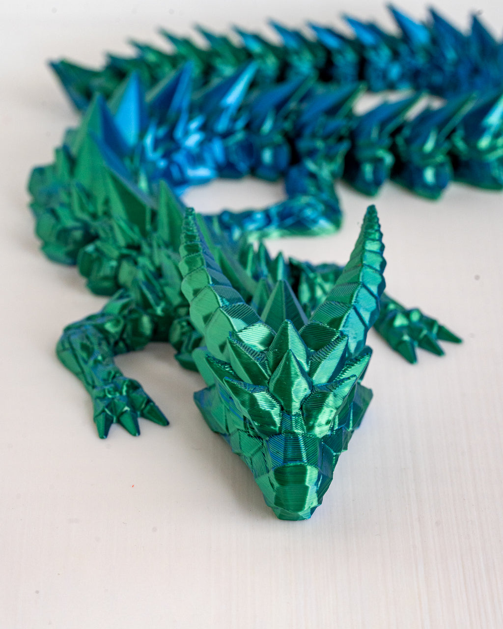 Green metallic dragon on a white background