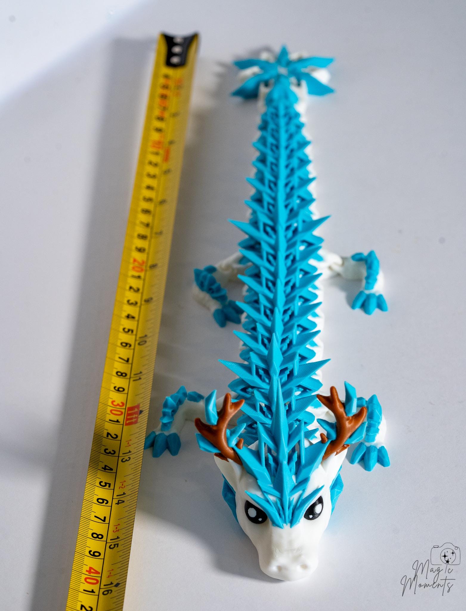 Ice dragon figure next to measuring tape for scale
