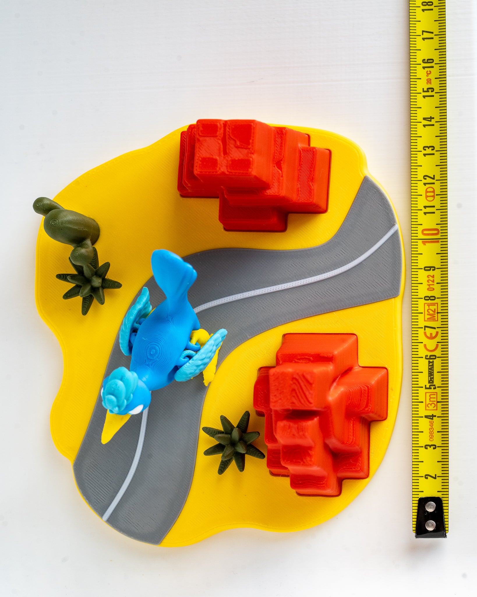 Road runner desert display set next to measuring tape for scale
