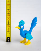 Road runner figure next to measuring tape for scale