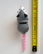Possum figure next to measuring tape for scale
