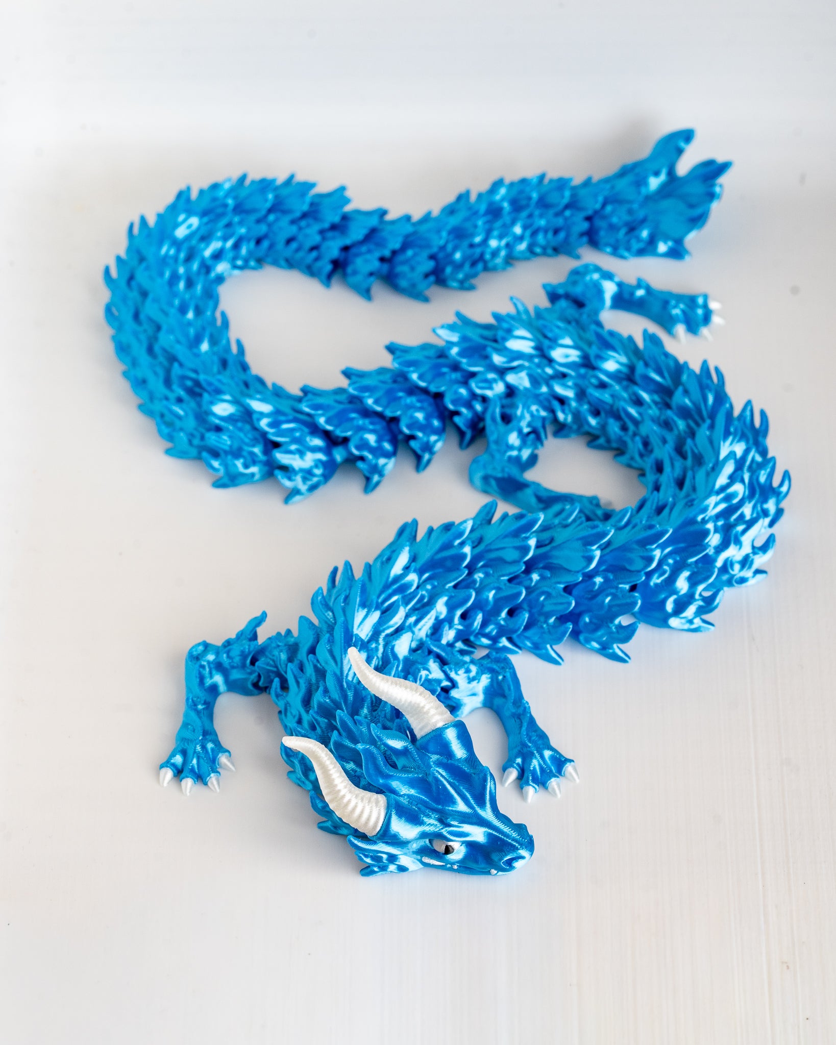 Blue dragon figure on a white background