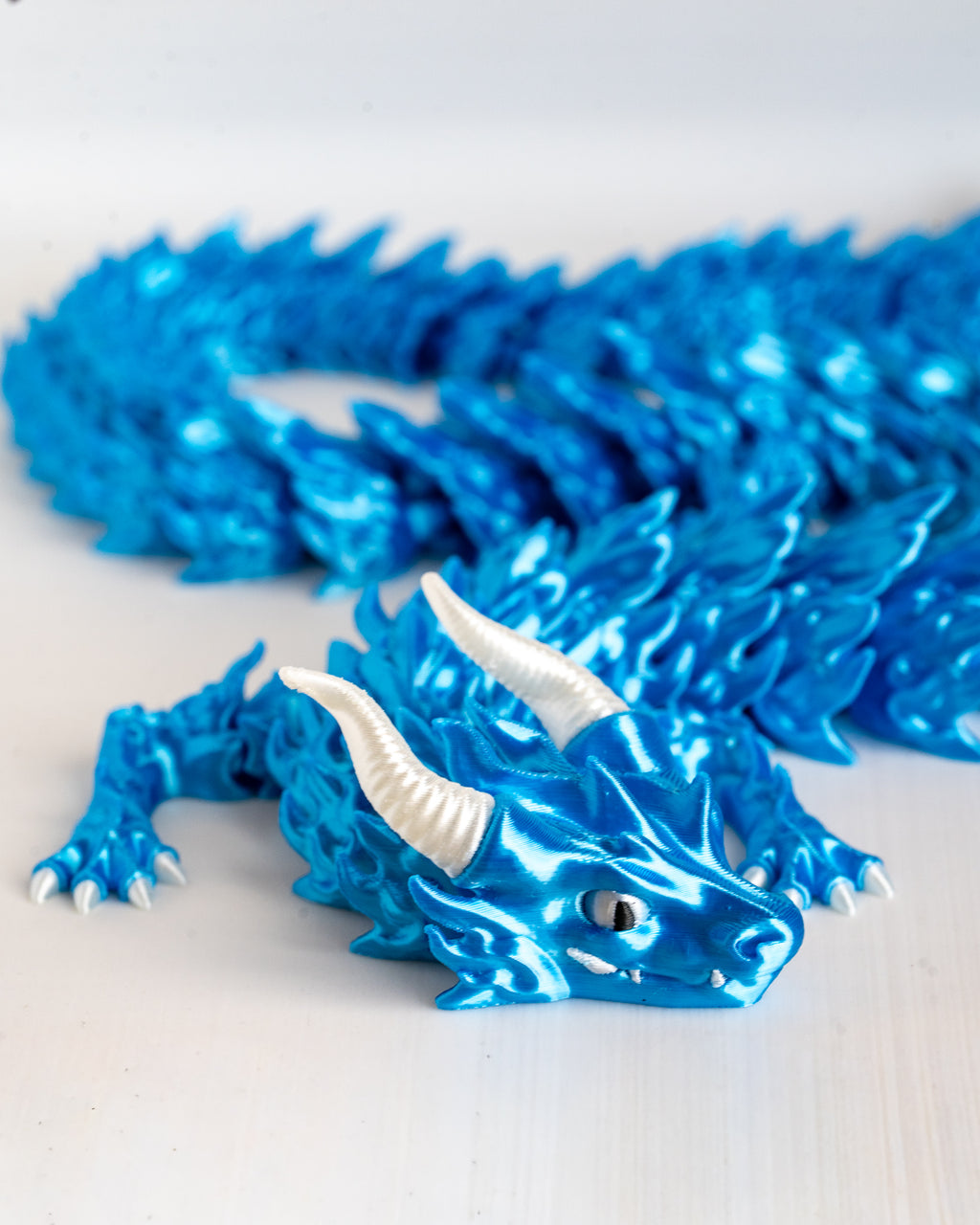 Blue dragon figurine on a white background