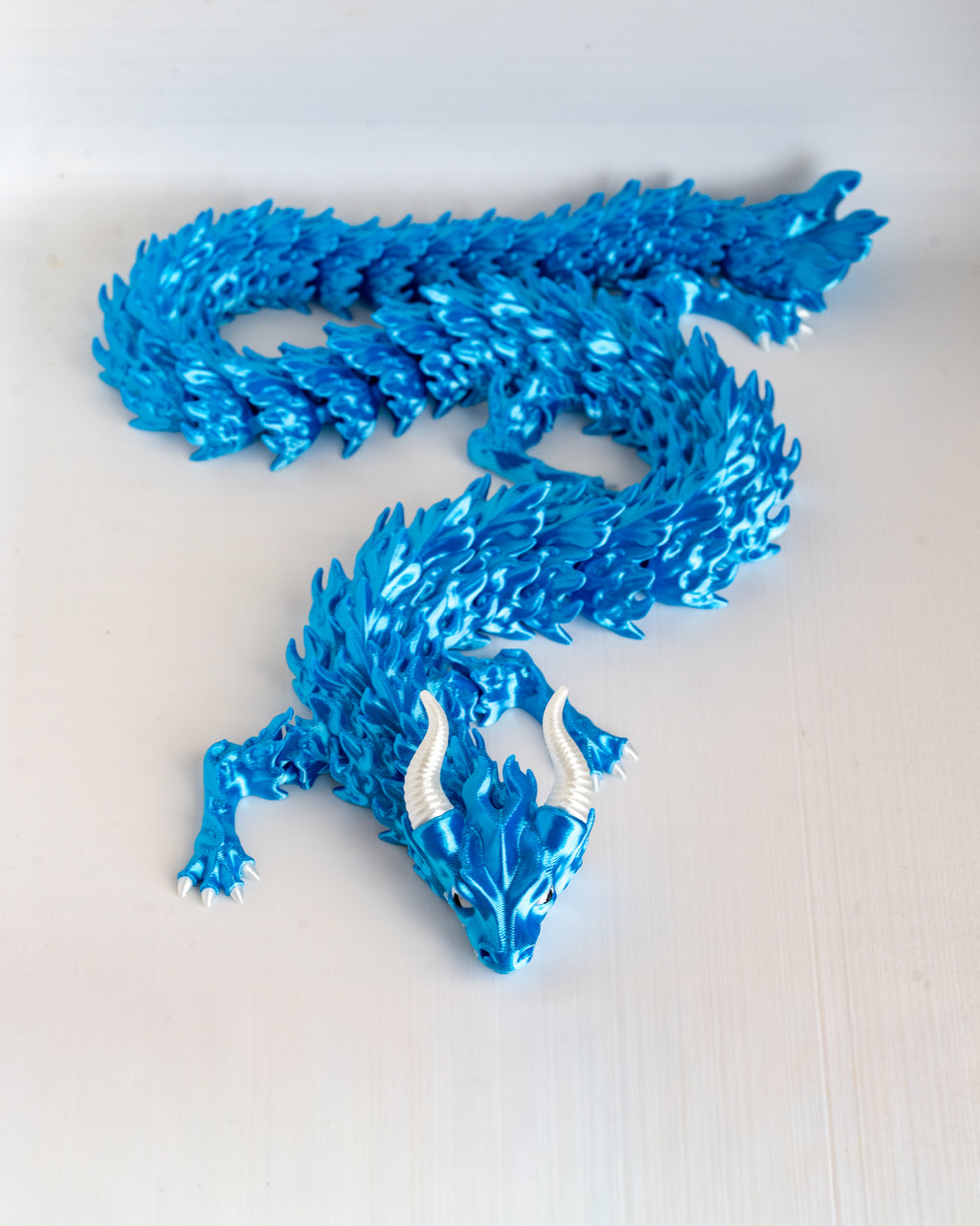 Blue dragon figurine on a white background