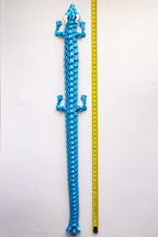 Blue dragon figurine next to a measuring tape on a white background