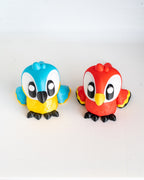 Two colorful bird-shaped figurines on a white background