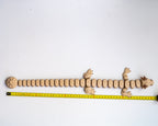 long 3d printed dumpling dragon figurine next to a measuring tape for a scale