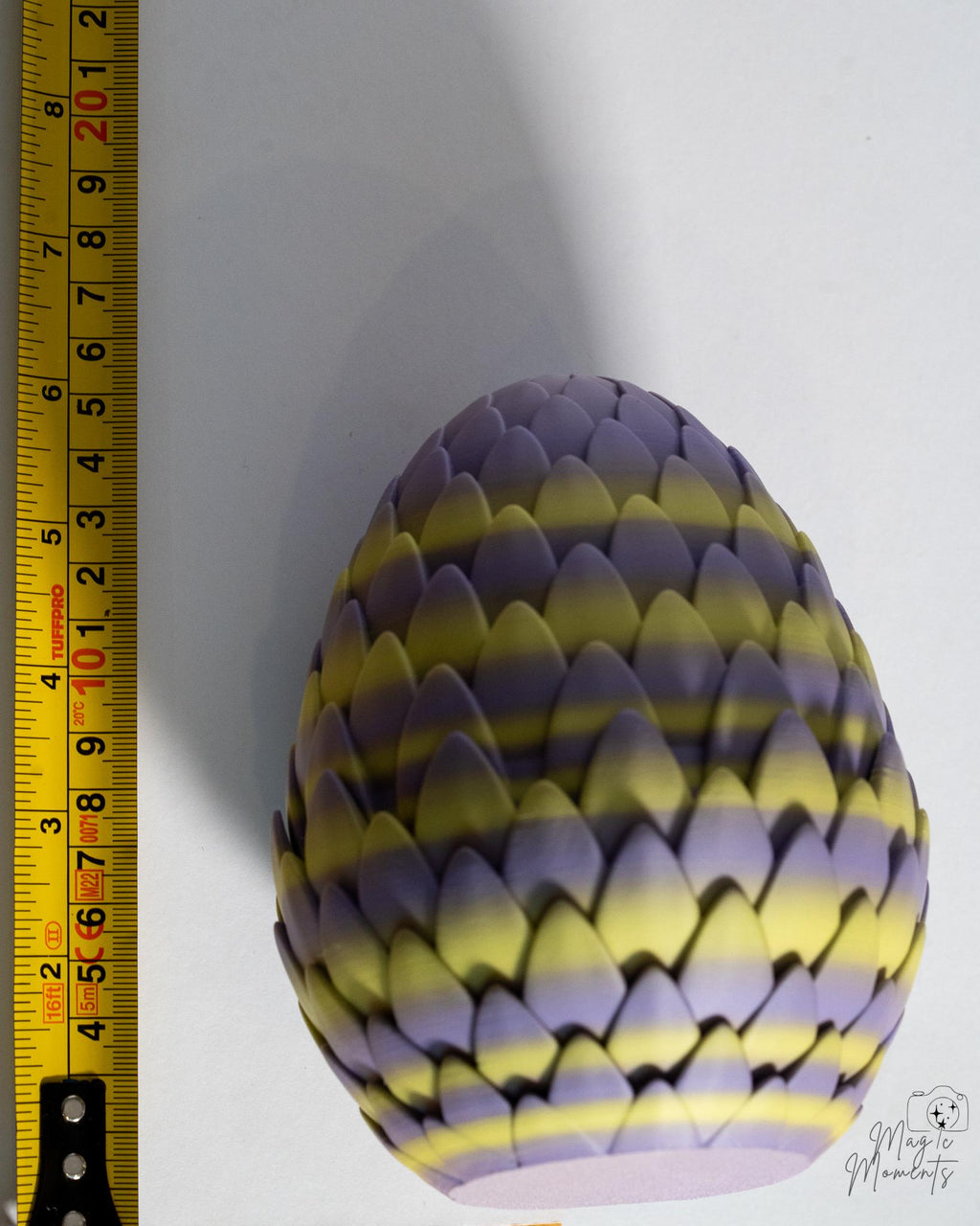 Dragon egg next to measuring tape for scale