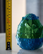 Dragon egg container next to measuring tape for scale