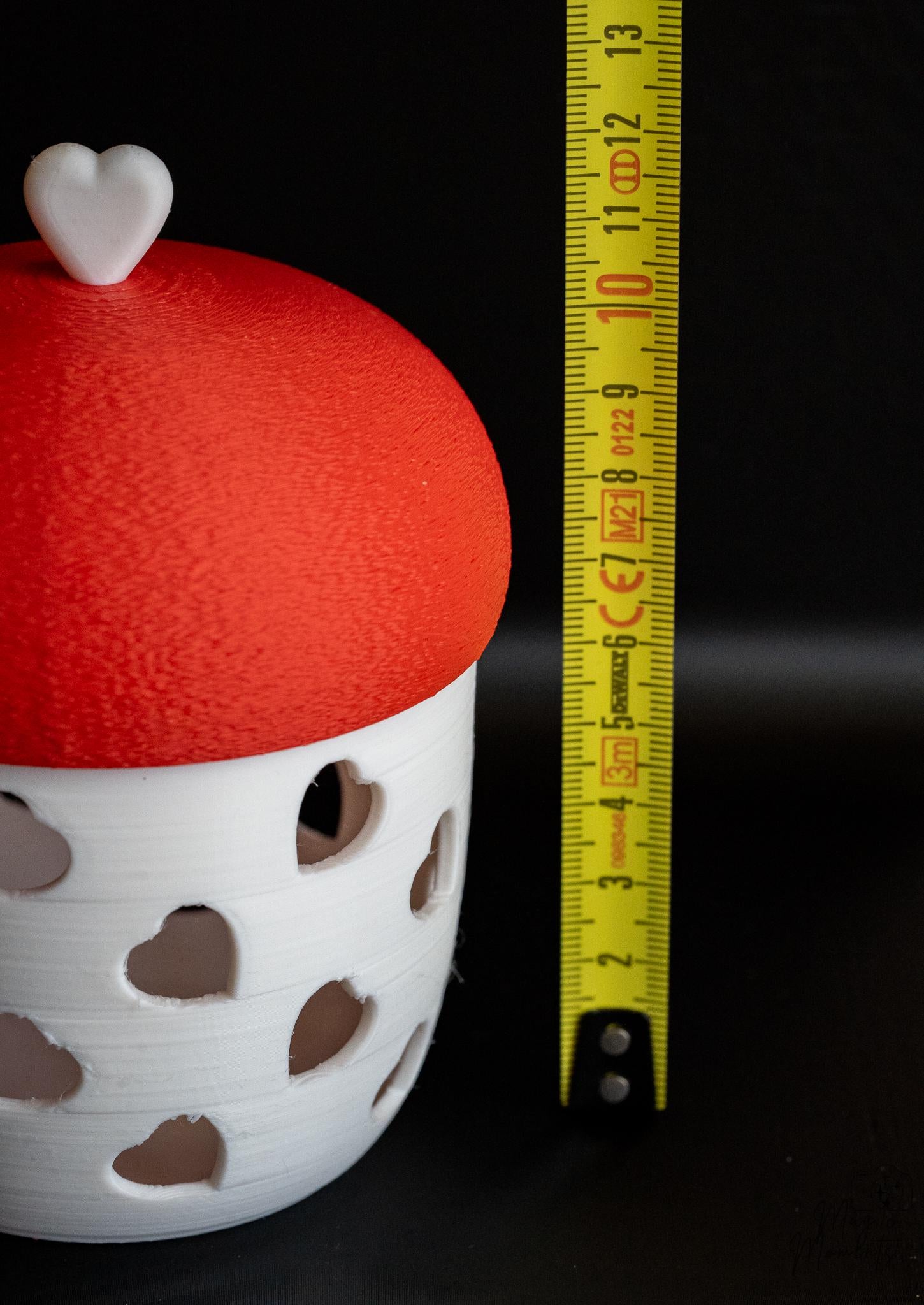 white tealight holder next to measuring tape for scale