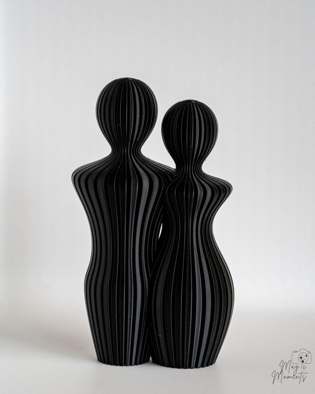 Black abstract couple sculpture with modern minimalist finish