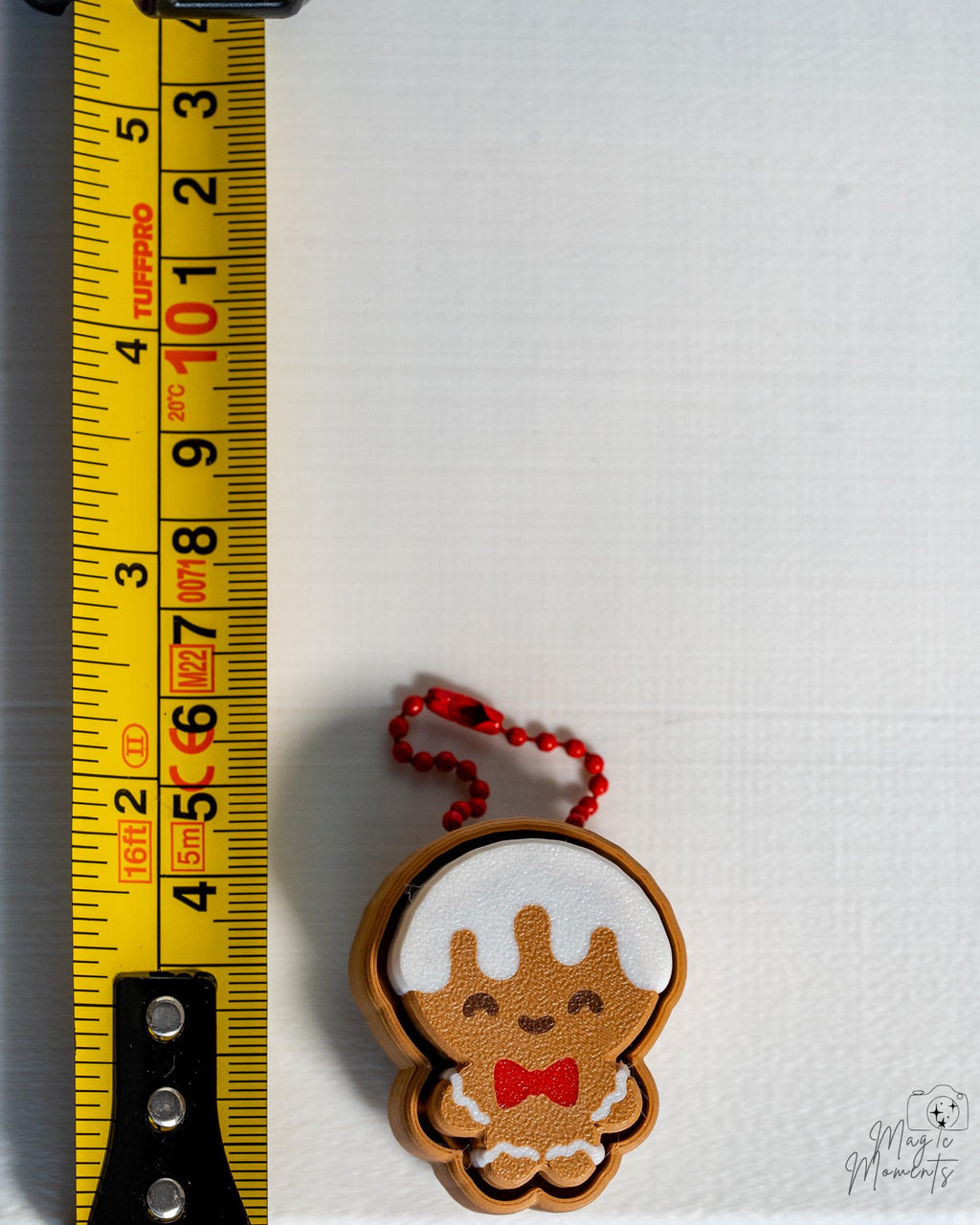 gingerbread man clicker next to measuring tape for scale