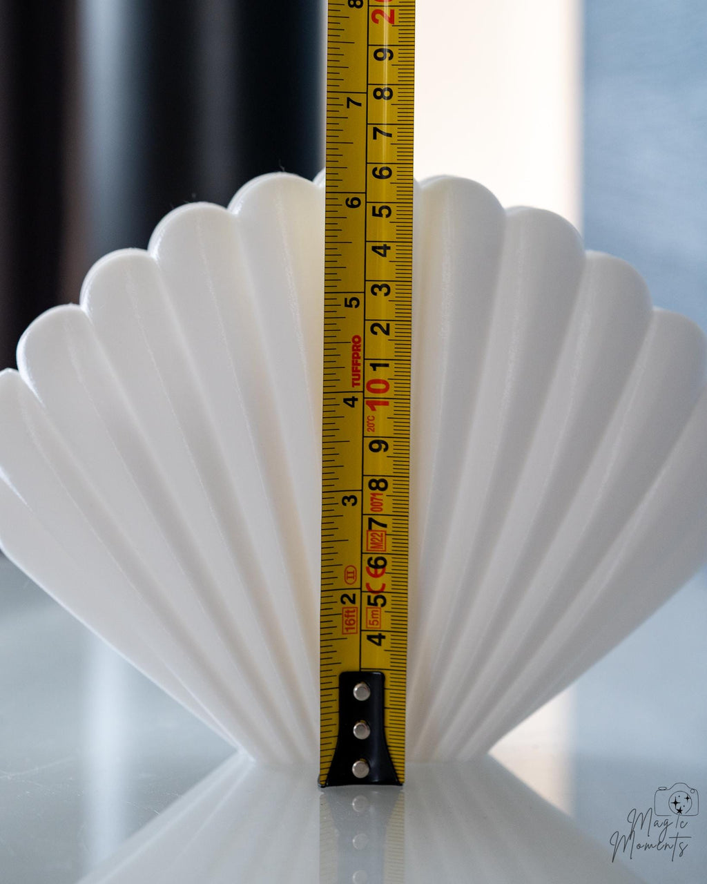 white shell napkin holder next to measuring tape for scale