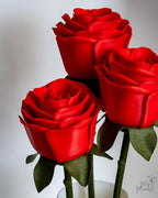 Red roses with green stems on a white background