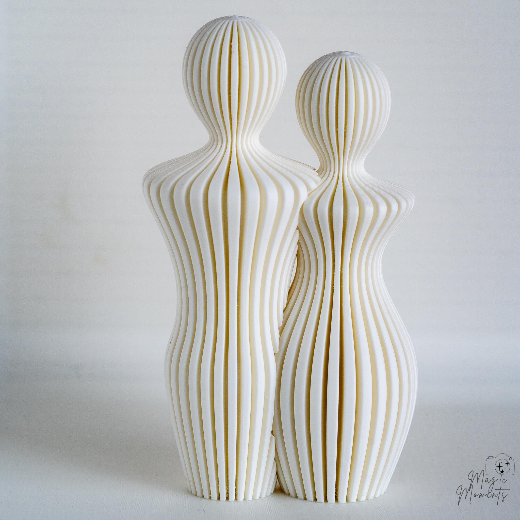 White abstract couple sculpture with minimalist curved design