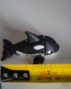orca killer whale figurine with a measuring tape for scale 