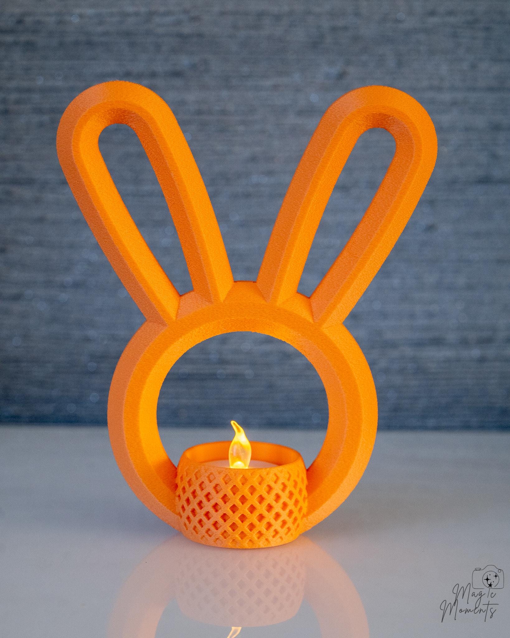 Orange bunny ear tealight holder glowing with LED candle