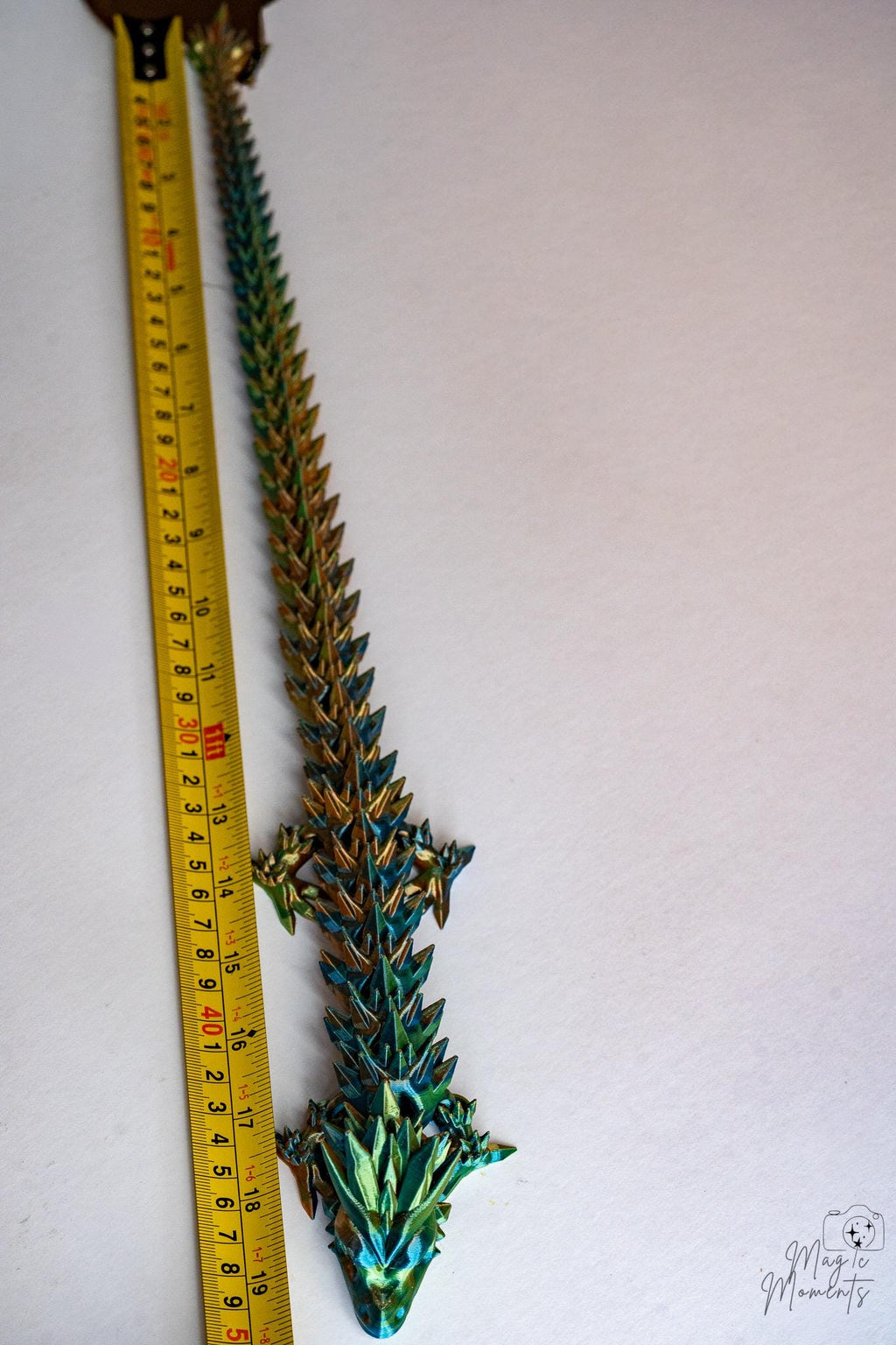 crystal dragon next to measuring tape for scale