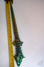 crystal dragon next to measuring tape for scale